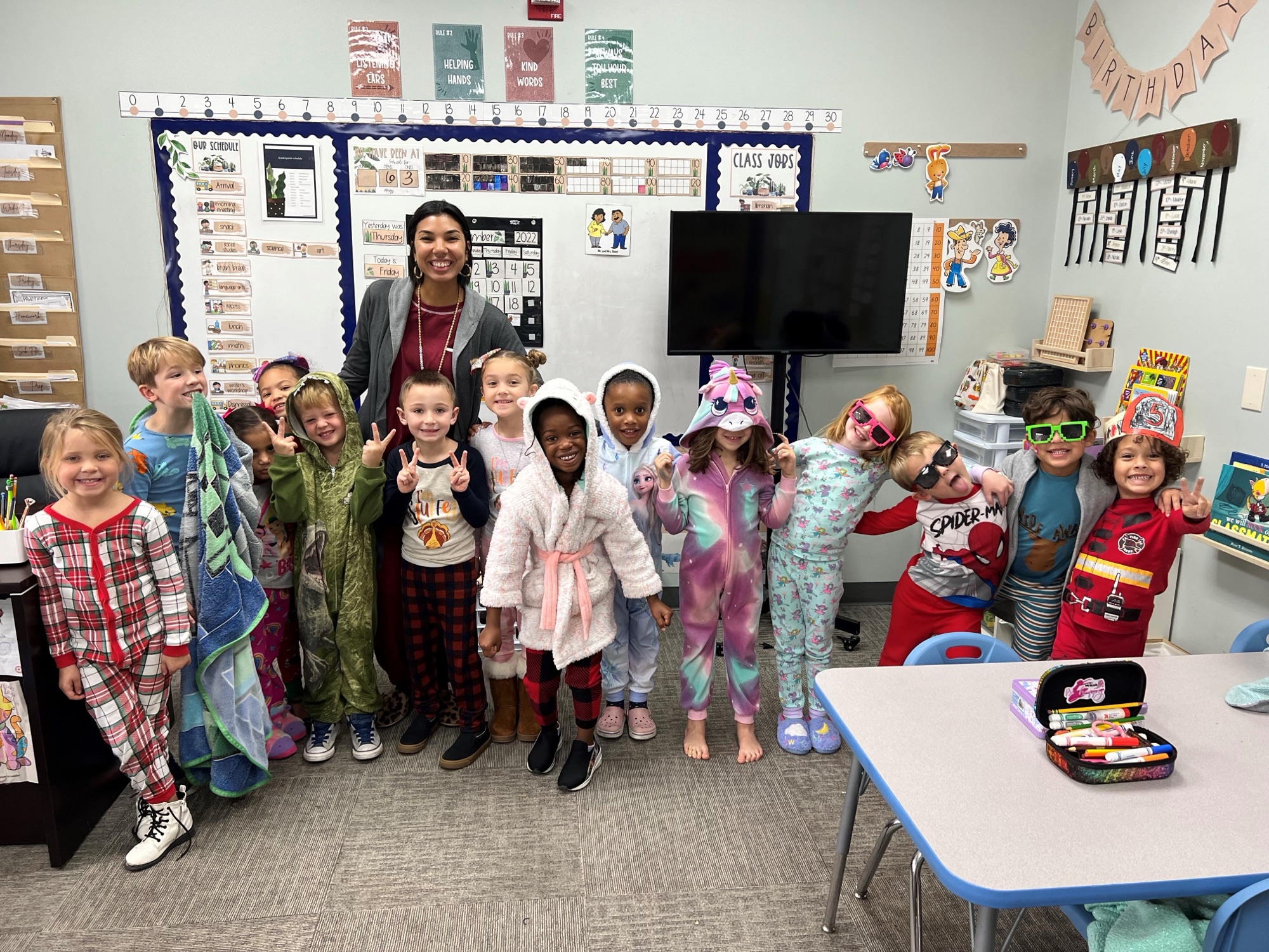 TRA kindergarteners on pajama day with their teacher