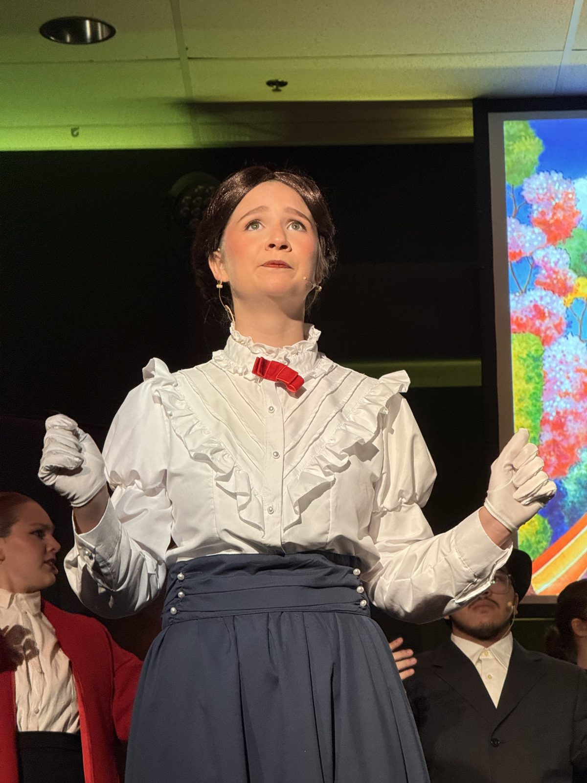 A lead performer mid-song in Mary Poppins